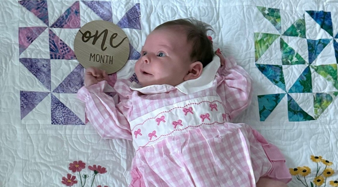 Another beautiful girl is welcomed into the world with a NC Stitches quilt.